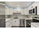 Modern kitchen featuring stainless steel appliances, sleek white cabinetry, and stylish countertops at 3500 Gussie St, Punta Gorda, FL 33950