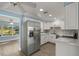 Bright kitchen with white cabinets, stainless steel appliances and light countertops at 3500 Gussie St, Punta Gorda, FL 33950