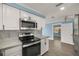 Modern kitchen featuring stainless steel appliances, sleek white cabinetry, and stylish countertops at 3500 Gussie St, Punta Gorda, FL 33950