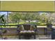 Relaxing balcony featuring a cushioned loveseat, side tables, and an open view of the manicured community grounds at 36750 Us 19 N # 22212, Palm Harbor, FL 34684