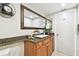 Bathroom with granite countertops, decorative mirror, and white door at 36750 Us 19 N # 22212, Palm Harbor, FL 34684