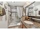 Updated bathroom featuring a glass enclosed shower with modern fixtures and granite counters at 36750 Us 19 N # 22212, Palm Harbor, FL 34684