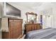 Bedroom with wooden floors featuring a large dresser and a large flat screen TV at 36750 Us 19 N # 22212, Palm Harbor, FL 34684