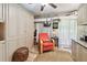 Bedroom showcasing a stylish red chair, wood flooring, and ample storage at 36750 Us 19 N # 22212, Palm Harbor, FL 34684