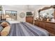 Cozy bedroom featuring wooden floors, decorative wall art, ceiling fan, and a large dresser at 36750 Us 19 N # 22212, Palm Harbor, FL 34684