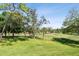 Scenic view of the golf course, surrounded by lush trees, providing a tranquil and picturesque backdrop at 36750 Us 19 N # 22212, Palm Harbor, FL 34684