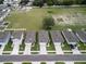 Wide aerial view of homes in a suburban neighborhood, showing proximity to green spaces and community areas at 3686 Zephyr Preserve Pl, Zephyrhills, FL 33541