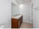 Bright bathroom with a double sink vanity, granite countertop and tile flooring at 3686 Zephyr Preserve Pl, Zephyrhills, FL 33541
