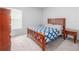 Inviting bedroom with matching wooden bed frame and side tables, plus a window at 3686 Zephyr Preserve Pl, Zephyrhills, FL 33541
