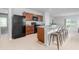 Kitchen boasts a large island with seating, stainless steel appliances, and sleek cabinetry at 3686 Zephyr Preserve Pl, Zephyrhills, FL 33541