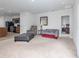 Open-concept living area connected to the kitchen, featuring neutral carpet and stylish furnishings at 3686 Zephyr Preserve Pl, Zephyrhills, FL 33541