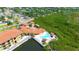 An aerial view of a waterfront apartment complex with a pool, offering serene living and outdoor amenities at 4302 Bayside Village Dr # 102, Tampa, FL 33615