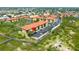 Aerial view showcases the condo complex alongside a scenic boardwalk trail winding through natural landscaping at 4302 Bayside Village Dr # 102, Tampa, FL 33615