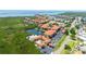 Aerial scene featuring a condo community, pond with fountain, pool and bordering wetlands with boardwalk access at 4302 Bayside Village Dr # 102, Tampa, FL 33615
