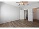 Bright bedroom with wood-look floors, ceiling fan, and walk-in closet at 4302 Bayside Village Dr # 102, Tampa, FL 33615