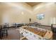 Versatile game room with foosball, ping pong, air hockey, and wall-mounted TV at 4302 Bayside Village Dr # 102, Tampa, FL 33615