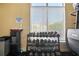 Well-maintained weight area complete with dumbbells, water cooler, and a notice board at 4302 Bayside Village Dr # 102, Tampa, FL 33615