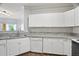 Modern condo kitchen featuring white cabinets, granite counters, and stainless steel appliances, offering a clean aesthetic at 4302 Bayside Village Dr # 102, Tampa, FL 33615
