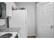 Functional kitchen space featuring granite countertops, modern appliances, and ample storage, adjacent to a convenient utility area at 4302 Bayside Village Dr # 102, Tampa, FL 33615