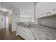Well-appointed kitchen featuring granite counters, white cabinets, and modern appliances, seamlessly connected to the living area at 4302 Bayside Village Dr # 102, Tampa, FL 33615