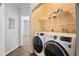 Convenient in-unit laundry area featuring modern washer and dryer, shelving, and clean finishes for effortless chores at 4302 Bayside Village Dr # 102, Tampa, FL 33615