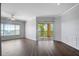 Open living room featuring a ceiling fan, wood flooring and sliding glass doors to the balcony at 4302 Bayside Village Dr # 102, Tampa, FL 33615