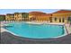 Community pool with lounge chairs and easy stair access at 4302 Bayside Village Dr # 102, Tampa, FL 33615