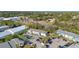 Aerial view of the condo complex, surrounded by trees and parking lots at 455 Alt 19 # 111, Palm Harbor, FL 34683
