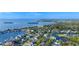 Scenic aerial view of a coastal community, showcasing waterfront homes and abundant trees at 455 Alt 19 # 111, Palm Harbor, FL 34683