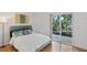Cozy bedroom with natural light, a sliding glass door and outdoor access at 455 Alt 19 # 111, Palm Harbor, FL 34683