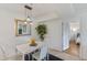 Cozy dining area with view into bedroom and illuminated by modern hanging light fixture at 455 Alt 19 # 111, Palm Harbor, FL 34683