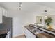 Modern kitchen with granite countertops, white cabinets, and stainless steel refrigerator at 455 Alt 19 # 111, Palm Harbor, FL 34683