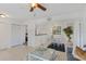 Open-concept living area with view of modern kitchen and dining space with natural light at 455 Alt 19 # 111, Palm Harbor, FL 34683