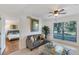 Welcoming living room with a comfortable couch and view of the bedroom at 455 Alt 19 # 111, Palm Harbor, FL 34683