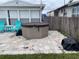 Backyard featuring a hot tub on a stone patio, perfect for outdoor relaxation at 4551 Floramar Ter, New Port Richey, FL 34652