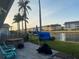 Backyard patio featuring a hot tub, outdoor seating, and lush greenery, with water views at 4551 Floramar Ter, New Port Richey, FL 34652