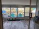 Enclosed porch area featuring seating, storage, and waterfront views from multiple windows at 4551 Floramar Ter, New Port Richey, FL 34652