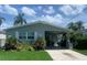 Charming single-story home featuring mature landscaping and a covered carport at 4551 Floramar Ter, New Port Richey, FL 34652