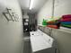Efficient laundry room featuring a washer, dryer, shelving, and water heater in a compact space at 4551 Floramar Ter, New Port Richey, FL 34652