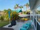 Outdoor patio with seating and lush landscaping, perfect for relaxing and enjoying the Florida weather at 4551 Floramar Ter, New Port Richey, FL 34652