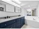 Beautiful bathroom with a soaking tub, granite countertop, and double vanity at 5482 Salem Square N Dr, Palm Harbor, FL 34685