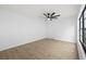 This bedroom features a ceiling fan and a large window for natural light at 5482 Salem Square N Dr, Palm Harbor, FL 34685