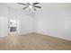 Spacious bedroom with new flooring and an open view to the ensuite bathroom at 5482 Salem Square N Dr, Palm Harbor, FL 34685