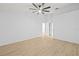 A large bedroom featuring a modern ceiling fan and an ensuite bathroom at 5482 Salem Square N Dr, Palm Harbor, FL 34685