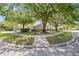Well-maintained home exterior with mature trees and landscaping, providing shade and curb appeal at 5482 Salem Square N Dr, Palm Harbor, FL 34685