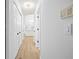 Long hallway leading into the kitchen, with access to closets at 5482 Salem Square N Dr, Palm Harbor, FL 34685