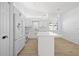 Modern kitchen featuring white cabinets, an island, stainless steel appliances, and ample storage space at 5482 Salem Square N Dr, Palm Harbor, FL 34685