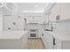 Well-lit kitchen with stainless steel appliances, white countertops, and ample storage space at 5482 Salem Square N Dr, Palm Harbor, FL 34685