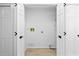 Laundry room includes washer and dryer hookups, storage shelves, and folding space at 5482 Salem Square N Dr, Palm Harbor, FL 34685