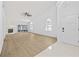Bright living room featuring wood flooring, a stone fireplace, and lots of light at 5482 Salem Square N Dr, Palm Harbor, FL 34685